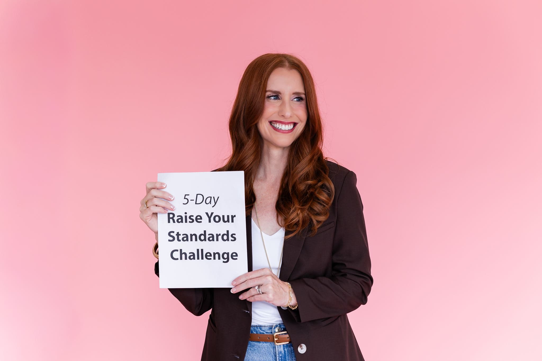 Jacqui Nelson holding the 5-Day Raise Your Standards Challenge sign